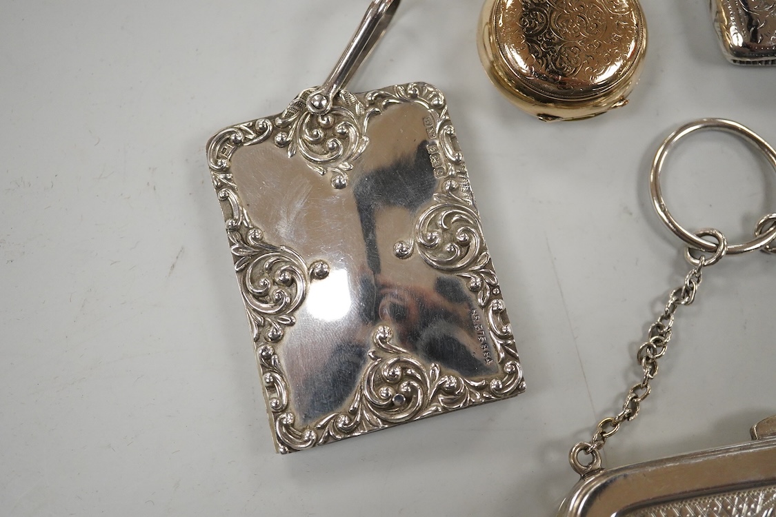 Two late Victorian silver twin compartment sovereign cases, Birmingham, 1891 & 1896, both approx. 57mm, a gold plated sovereign case, together with three silver vesta cases, a silver purse and a silver mounted notebook.